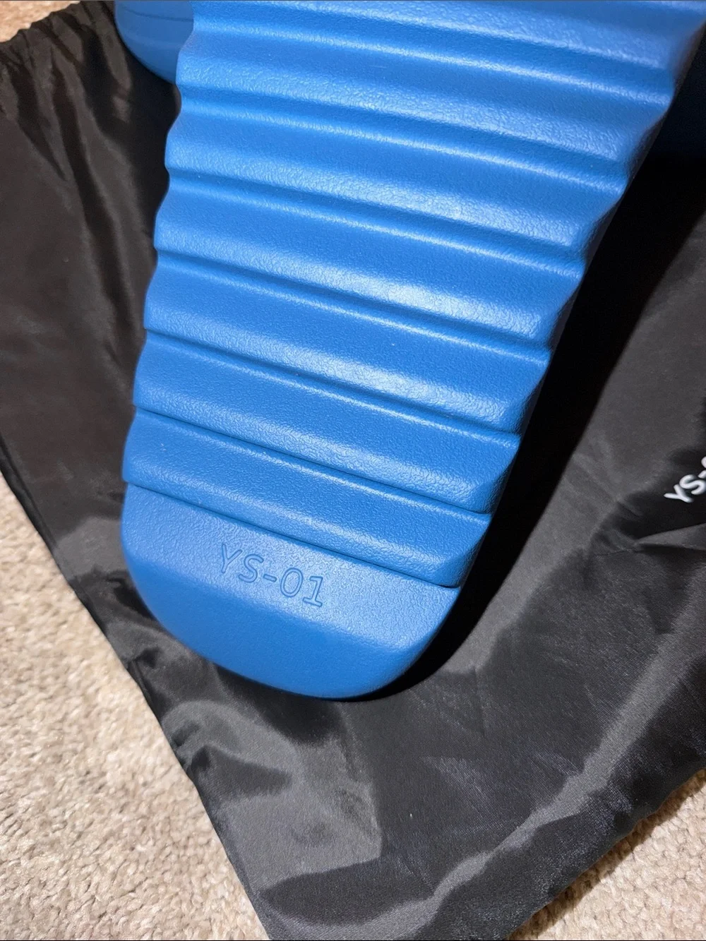 foam runner/slides inspired by Yeezy‎ designs. The bag says “YS-01,”